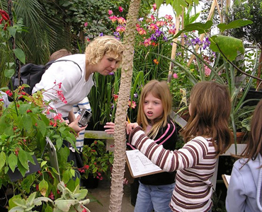 Homeschool parent and kids in the Arboretum's greenhouse