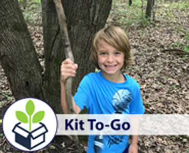 kit recipient playing outdoors in nature.