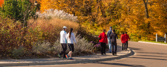 People walking on a paved trail with fall colors 
