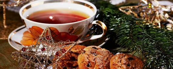 Red tea with cookies and a holiday star ornament