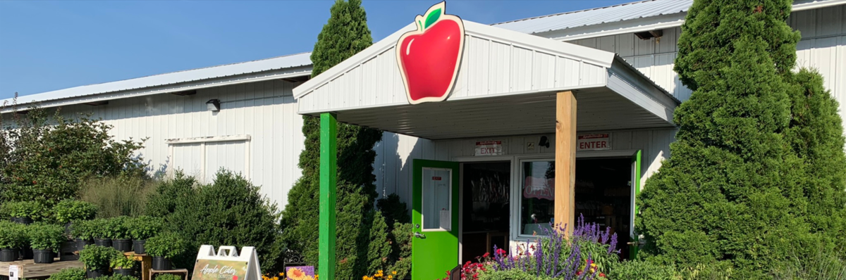 AppleHouse entrance with red apple logo and green doors. 