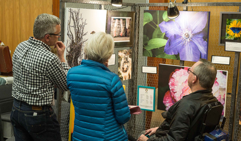 People looking at art at the February art fair