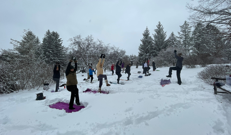 People doing yoga poses in snow
