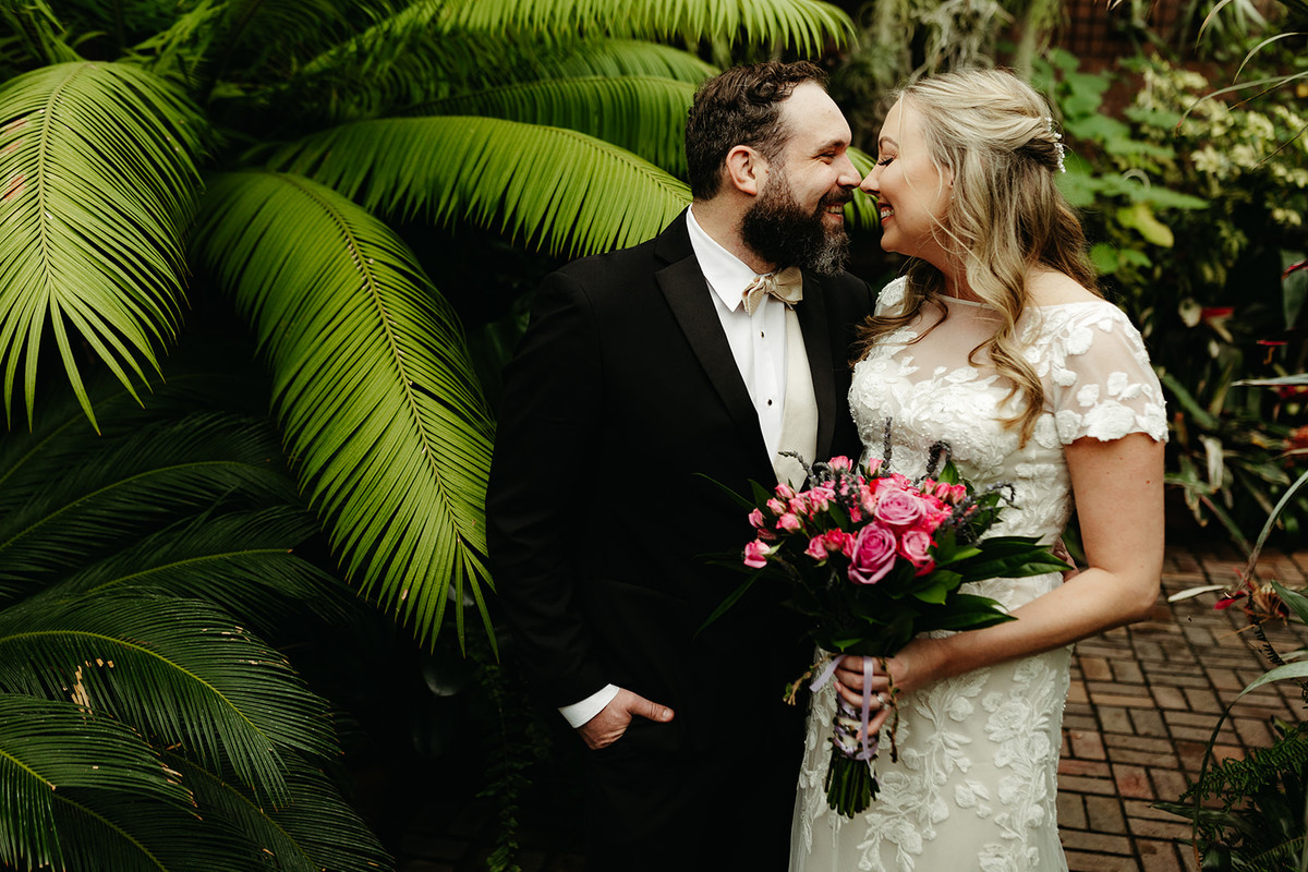 Wedding couple in front of a palm in the conservatory