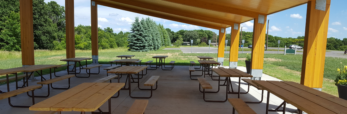 Picnic tables underneath the sweasy picnic shelter
