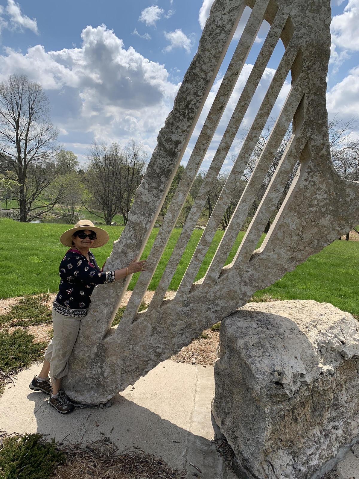 Woman standing next to the stone harp