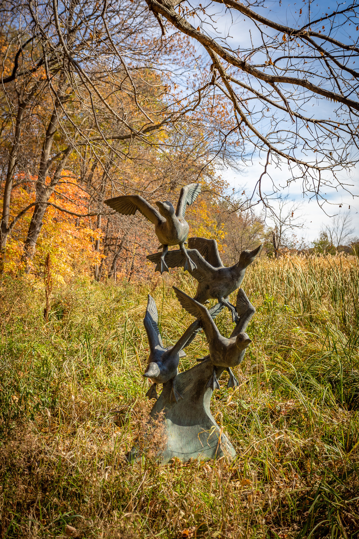 Birds in flight sculpture in the fall