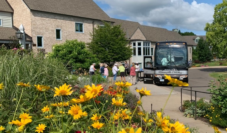 People loading onto the bus for the garden tours