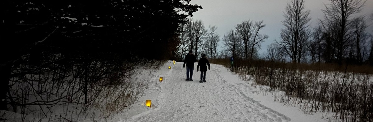 Couple walking at dusk in snowshoes
