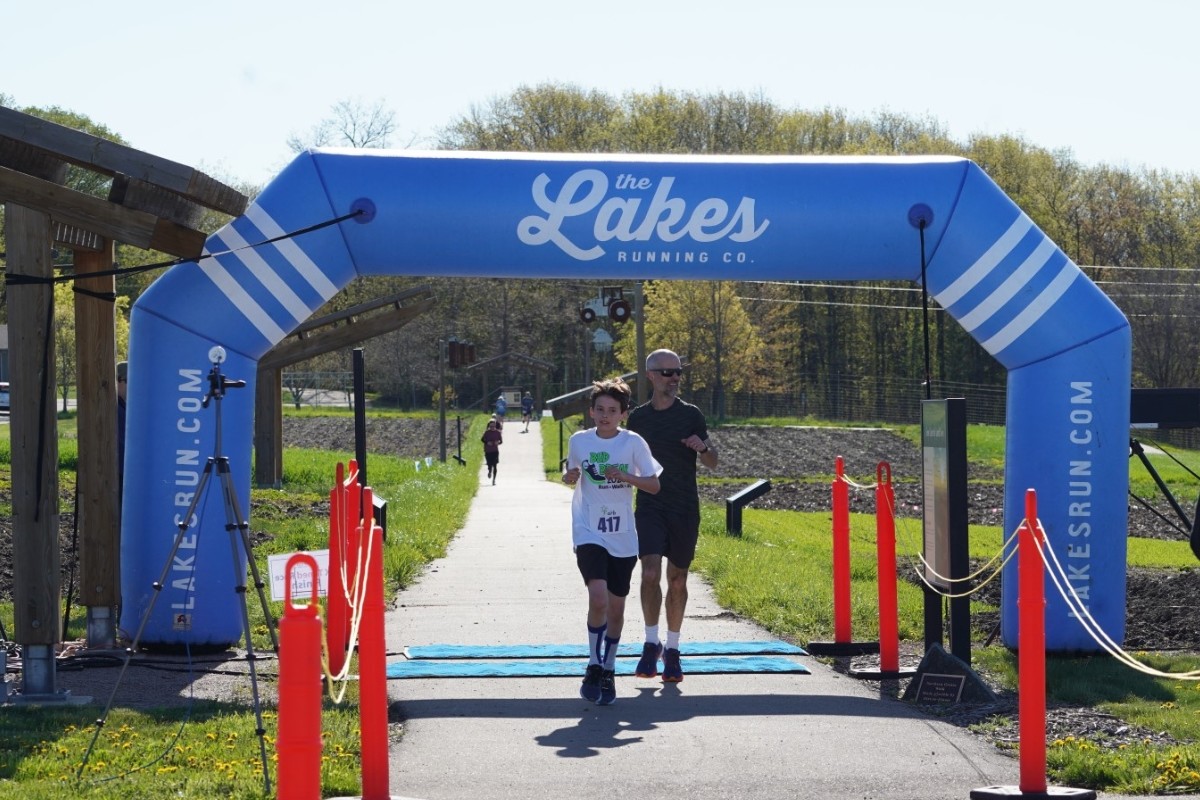 Dad and son crossing the finish line