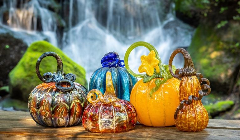 Glass pumpkins in front of the waterfall